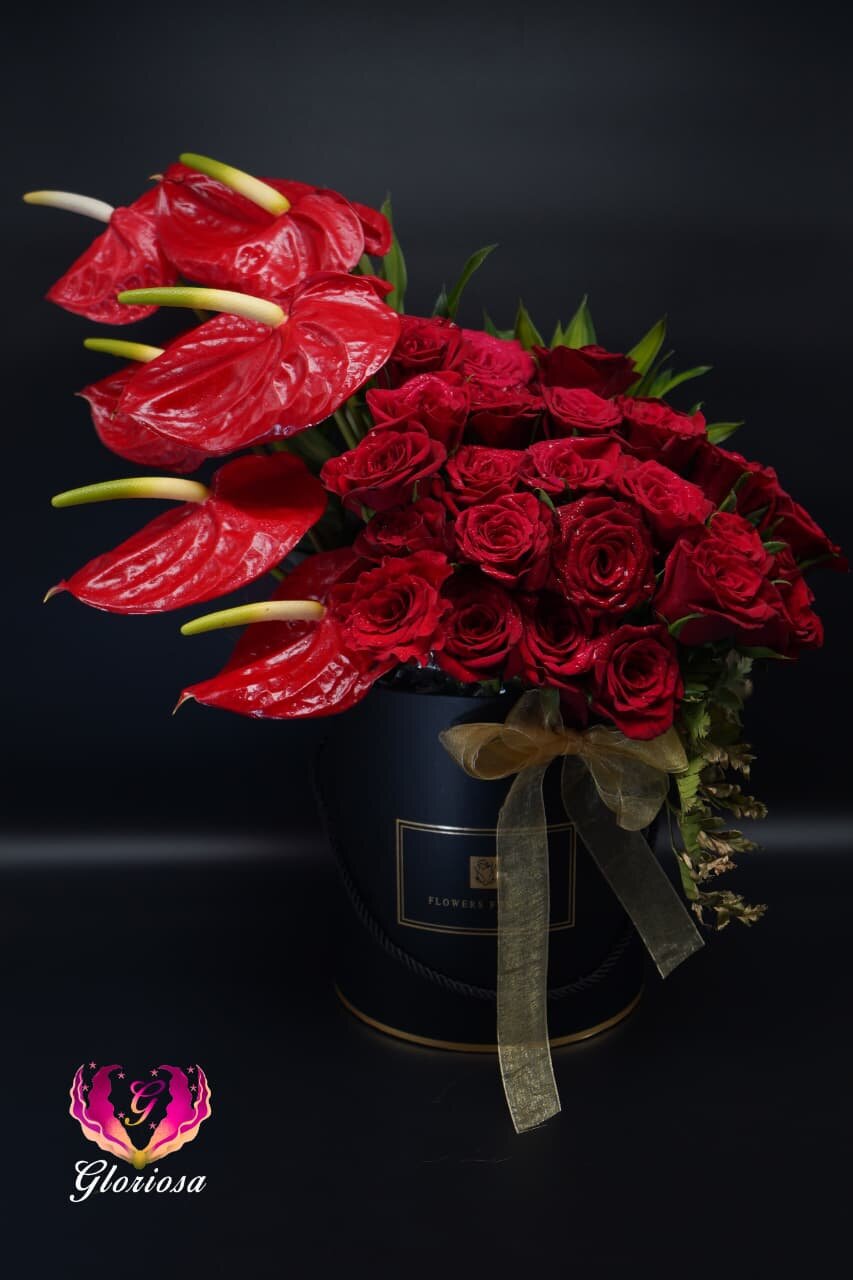 Red anthurium and roses in luxury black hat box