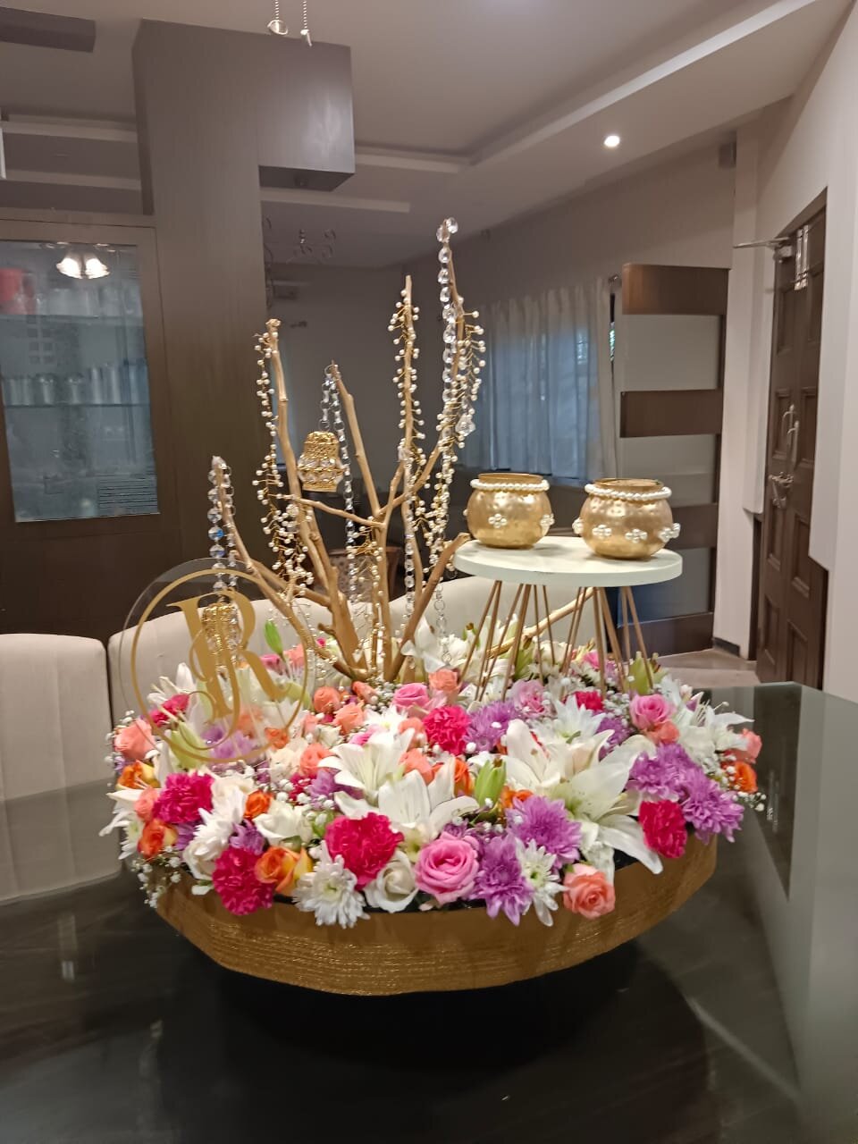 Enchanted flower arrangement under glass dome with fairy lights