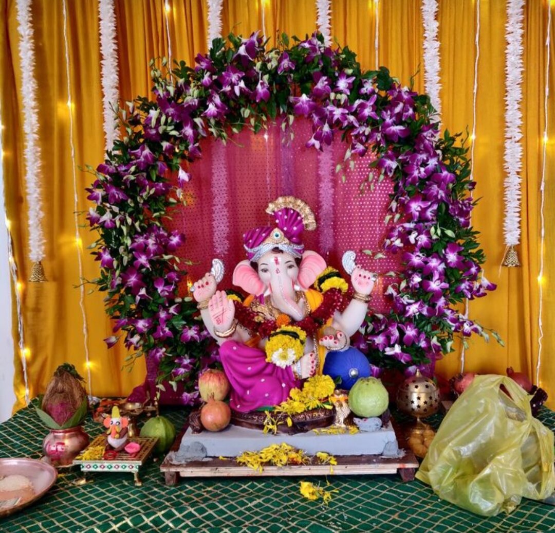 Ganpati decoration with purple orchid arch and fairy lights