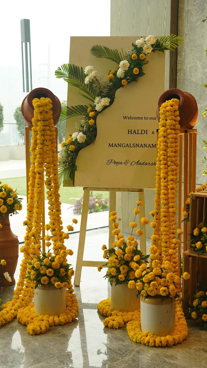 Haldi ceremony welcome board with marigold garlands